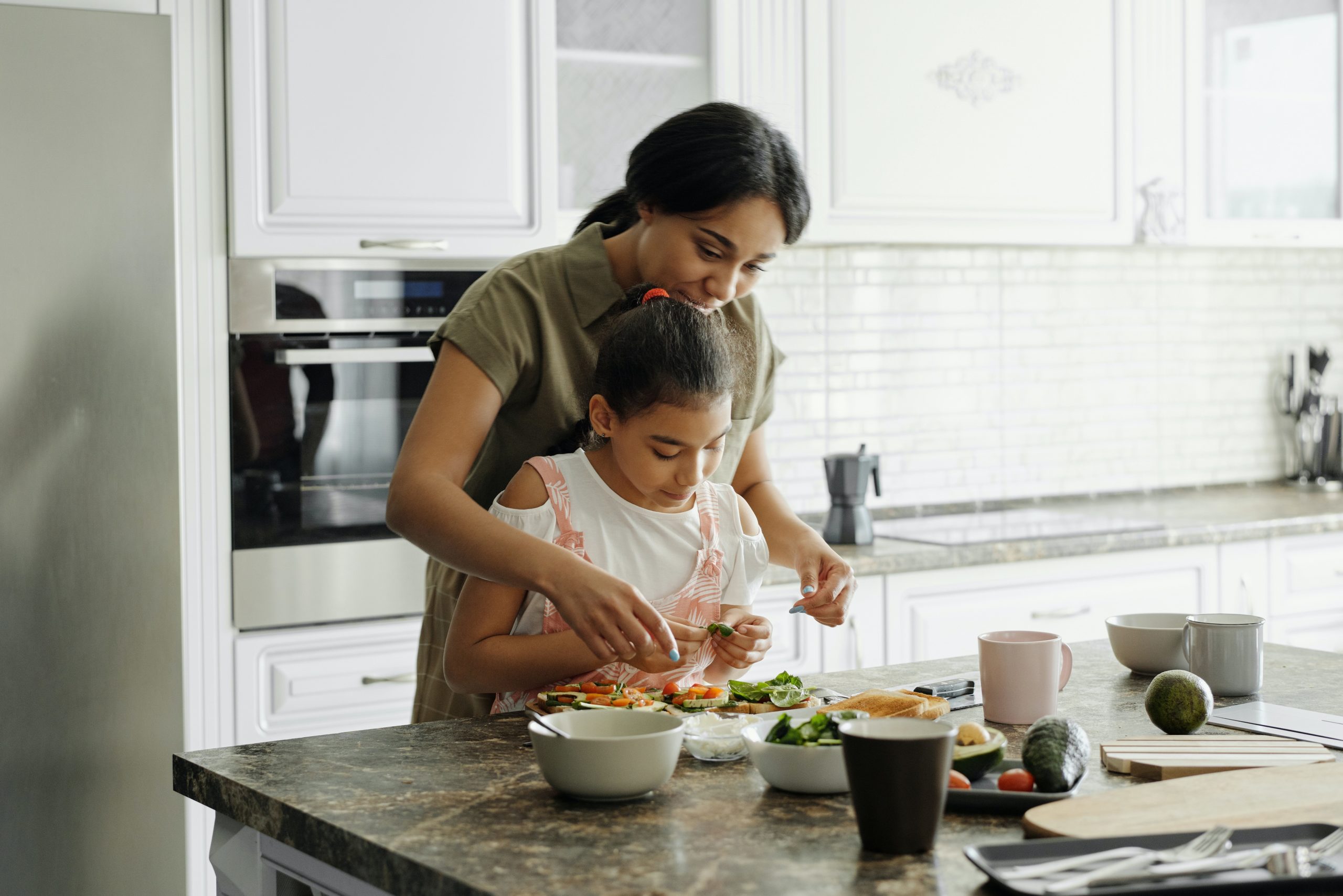 Mom and daughter cooking in the home kitchen